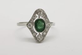 Emerald & Diamond Ring, oval bezel set emerald with a diamond surround, 2 prominent (top and