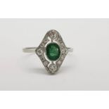 Emerald & Diamond Ring, oval bezel set emerald with a diamond surround, 2 prominent (top and