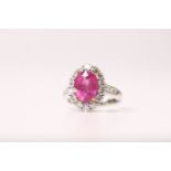 Pink Sapphire & Diamond Cluster Ring, oval pink sapphire held by yellow gold claws, surrounded by