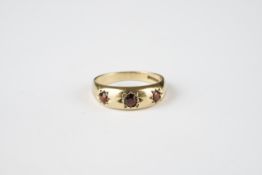 9CT GOLD THREE STONE GYPSY GARNET SET RING, gross weight is 3.03g.