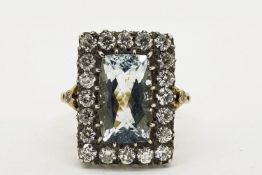 A Diamond Framed Aquamarine Ring, the precious stones are silver-set on 18ct yellow gold