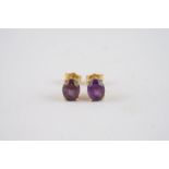 18CT GOLD AMETHYST SET STUD EARRINGS, a pair of 18ct gold studs set with est. 1ct amethyst