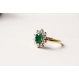 Emerald & Diamond Ring, set with an oval cut emerald, surrounded by 10 round brilliant cut diamonds,