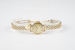 LADIES OMEGA 9CT GOLD COCKTAIL WATCH W/ PENDANT, circular champagne dial with stick hour markers and