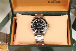 ROLEX SUBMARINER REFERENCE 16610 WITH BOX AND PAPERS 1994, circular black dial with applied baton