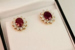 Pair of 9ct yellow gold ruby and diamond cluster earrings, boxed. Oval-cut rubies 3.85ct. Diamonds