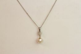 9ct white gold pearl and diamond drop pendant and chain, boxed. Diamonds 0.08ct