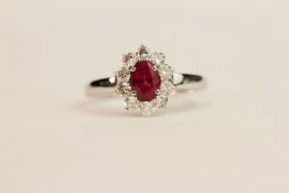 Certificated 18ct white gold oval ruby and diamond cluster ring. Ruby 0.50ct. Round brilliant cut