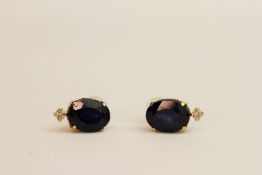 Pair of 18ct yellow gold stud earrings set with oval sapphire and round-cut diamond, boxed.