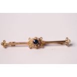 15ct Edwardian Sapphire and Pearl bar brooch, central blue sapphire within a cluster of pearls,