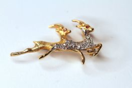 18CT PAIR OF SPRINGBOK DIAMOND SET BROOCH WITH RUBY EYES, total weight 4.6gms.