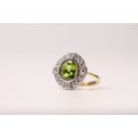 Peridot & Diamond Ring, white gold rub over set peridot inside a diamond “compass” surround with the
