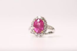 Pink Sapphire & Diamond Cluster Ring, oval pink sapphire held by yellow gold claws, surrounded by