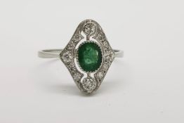 Emerald & Diamond Ring, oval bezel set emerald with a diamond surround, 2 prominent (top and