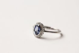 Sapphire & Diamond Ring, set with an oval cut natural sapphire 1.43ct, surrounded by 18 round