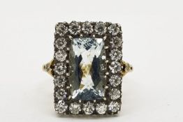 A Diamond Framed Aquamarine Ring, the precious stones are silver-set on 18ct yellow gold,