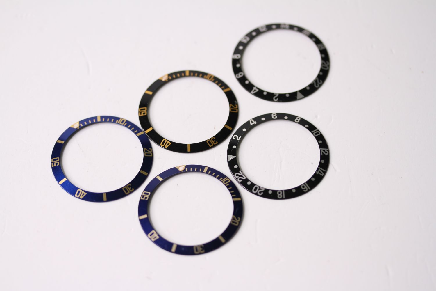 5x ROLEX BEZEL INSERTS, INCLUDING GMT AND BI-COLOUR SUBMARINERS, group of 5 Rolex bezel inserts,