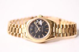 LADIES 18CT ROLEX DATEJUST AUTOMATIC, circular black dial with applied hour markers, date function