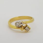 18 carat yellow gold "friendship" ring set with a princess cut and round cut diamond. Stamped 18K