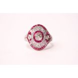 A platinum ruby and diamond ring. Old-cut centre diamond 0.63ct. Remaining diamonds 0.38ct. Rubies