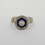 18 carat white gold c1960 French cut sapphire and diamond target ring with decorative detailing.