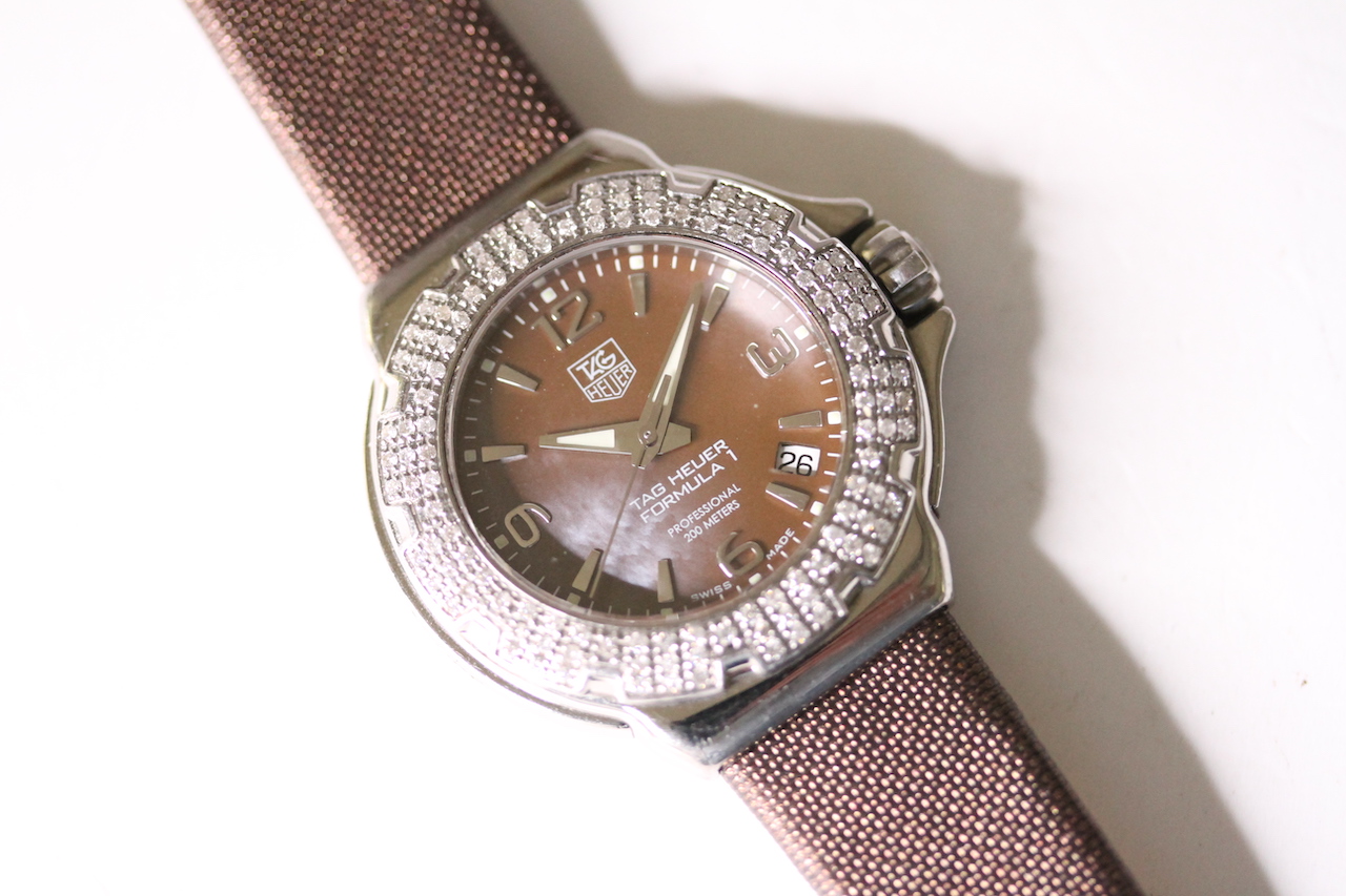 TAG HEUER FORMULA 1 WITH DIAMOND BEZEL QUARTZ WATCH, circular brown dial with baton and arabic