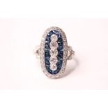 Platinum sapphire and diamond ring set with five vertical graduated diamonds, surrounded by