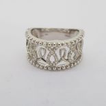 18 carat wide band ring. Openwork detail with millegrain and round brilliant diamonds. Ring is