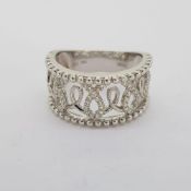 18 carat wide band ring. Openwork detail with millegrain and round brilliant diamonds. Ring is