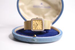 VINTAGE 18CT JAEGER LE-COULTRE WRIST WATCH WITH DIAMOND BEZEL AND JLC BOX, cushion champagne dial