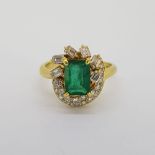 18 carat yellow gold Emerald and Diamond dress ring. The emerald cut Emerald is approximately 2