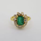 18 carat yellow gold Emerald and Diamond dress ring. The emerald cut Emerald is approximately 2