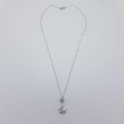 White gold diamond pendant suspended on a marked 18 carat 40cm white gold chain. Diamond content
