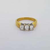 18 carat yellow gold ring with 3 Emerald cut diamonds set in white gold. Total diamond weight