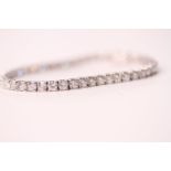 18ct white gold diamond line bracelet set with 8.20ct round brilliant cut diamonds in 4-claw mounts,