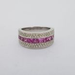 18 carat white gold wide band ring stamped 18K 750. 10 French cut pink sapphires weighing 1.74