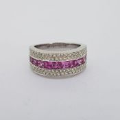 18 carat white gold wide band ring stamped 18K 750. 10 French cut pink sapphires weighing 1.74