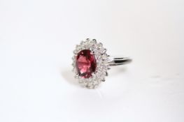 Pink Tourmaline and Diamond Cluster Ring, oval vibrant pink tourmaline, 10.7x8.5mm, with bright