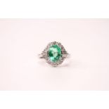 18ct white gold oval emerald and diamond cluster ring. Emerald 2.01ct. Diamonds 0.78ct (round-cut