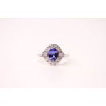 18ct white gold oval tanzanite and diamond cluster ring. Tanzanite 1.06ct. Diamonds 0.51ct (round-