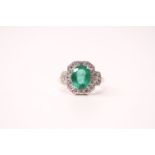Art Deco-style 18ct white gold oval emerald and diamond cluster and shoulders ring. Emerald 2.