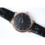 VINTAGE 18CT IWC WRIST WATCH 1956, circular black dial with gold baton hour markers, 36mm 18ct