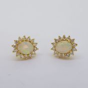 18 carat yellow gold opal and diamond earrings, posts and butterflies stamped 18K. Opals