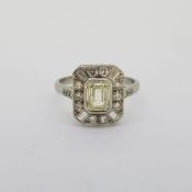 Platinum tablet ring with a central Emerald cut diamond of approximately 1.01cts. The surround of