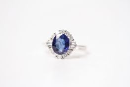 Fine quality 18ct white gold oval-cut sapphire and RBC and baguette diamond cluster ring. Sapphire