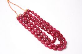 Large and weighty earth-mined oval carved ruby bead necklace with adjustable slip knot, cord and
