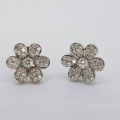 Tested 18 carat white gold large daisy shaped diamond set earrings. Diamond weight approximately1.50