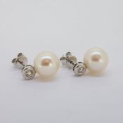 White gold bezel set diamond and freshwater pearl earrings. Butterflies stamped 750