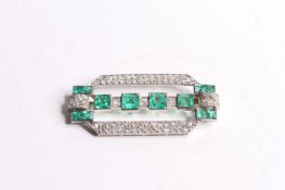 Columbian Emerald & Diamond Deco Brooch, set with 12 emeralds, approximately 45 x 21mm.
