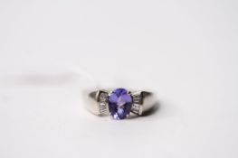 Tanzanite & Diamond Ring, set with an oval cut tanzanite, claw set, baguette cut diamonds, 18ct